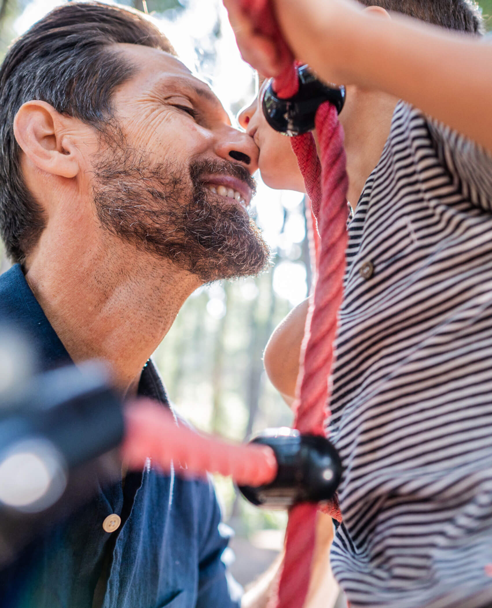 Child playing with father at the playground - Hotel Fameli