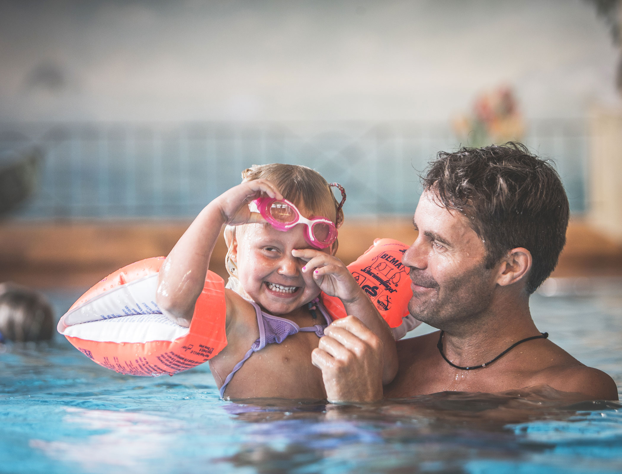 Man and child having fun in the pool - Hotel Fameli