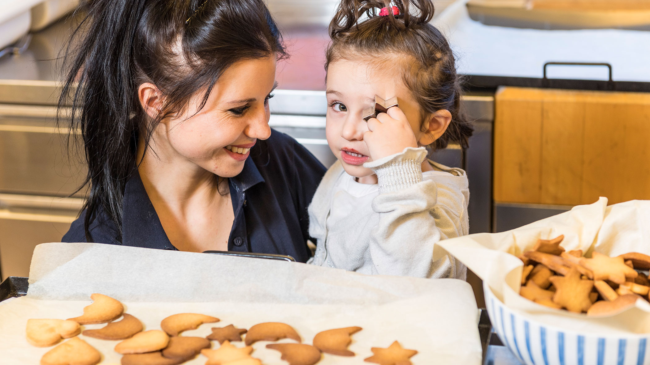 Wife and child baking cookies - Hotel Fameli