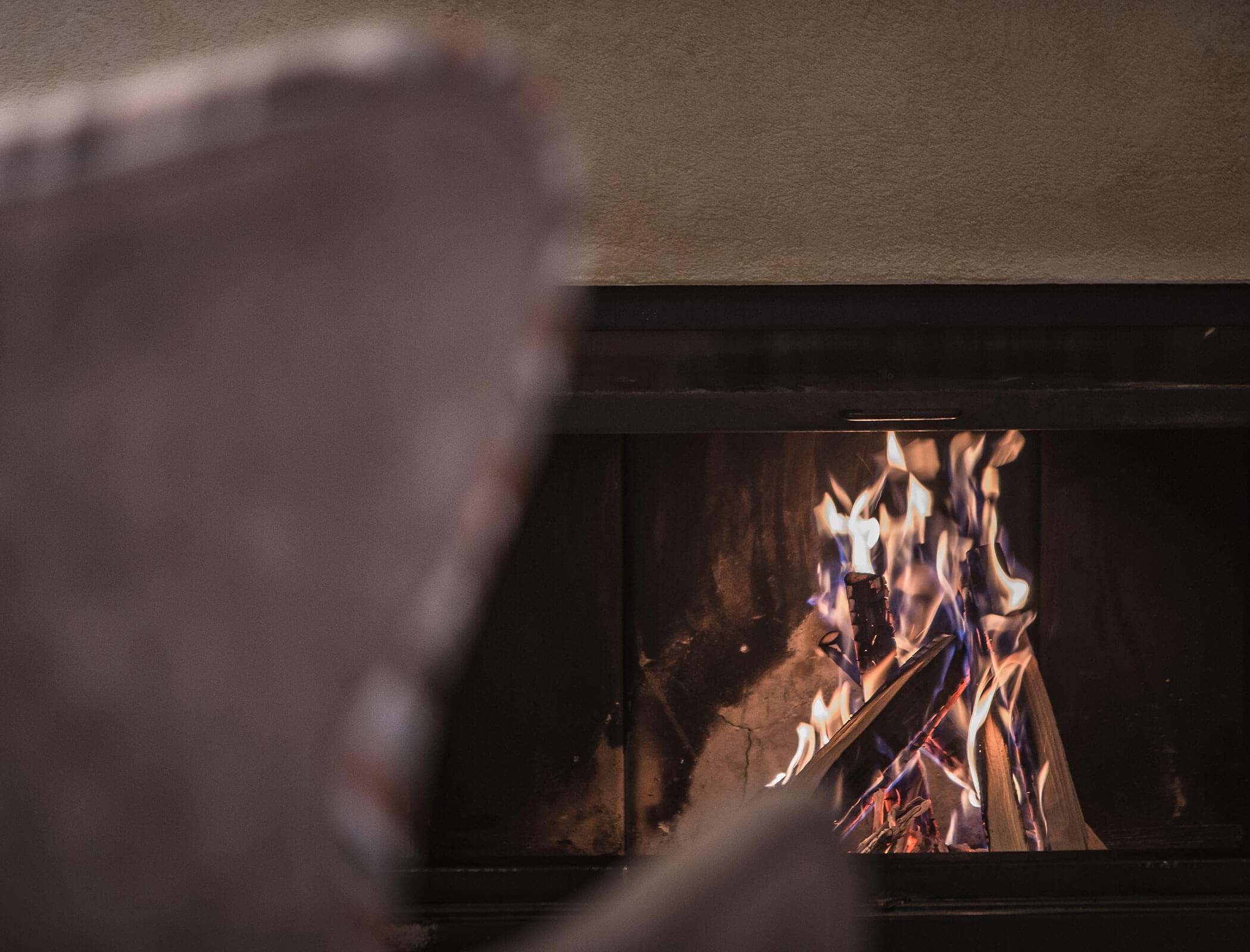 Fire in the fireplace detail photo - Hotel Fameli