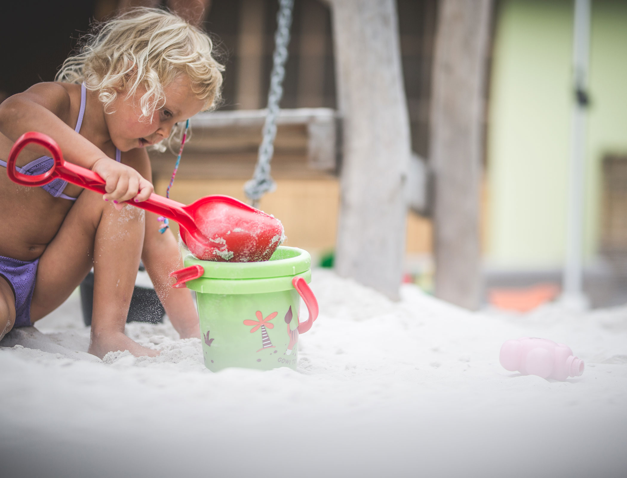 Children's playground with sandpit - girl playing with bucket and shovel - Hotel Fameli