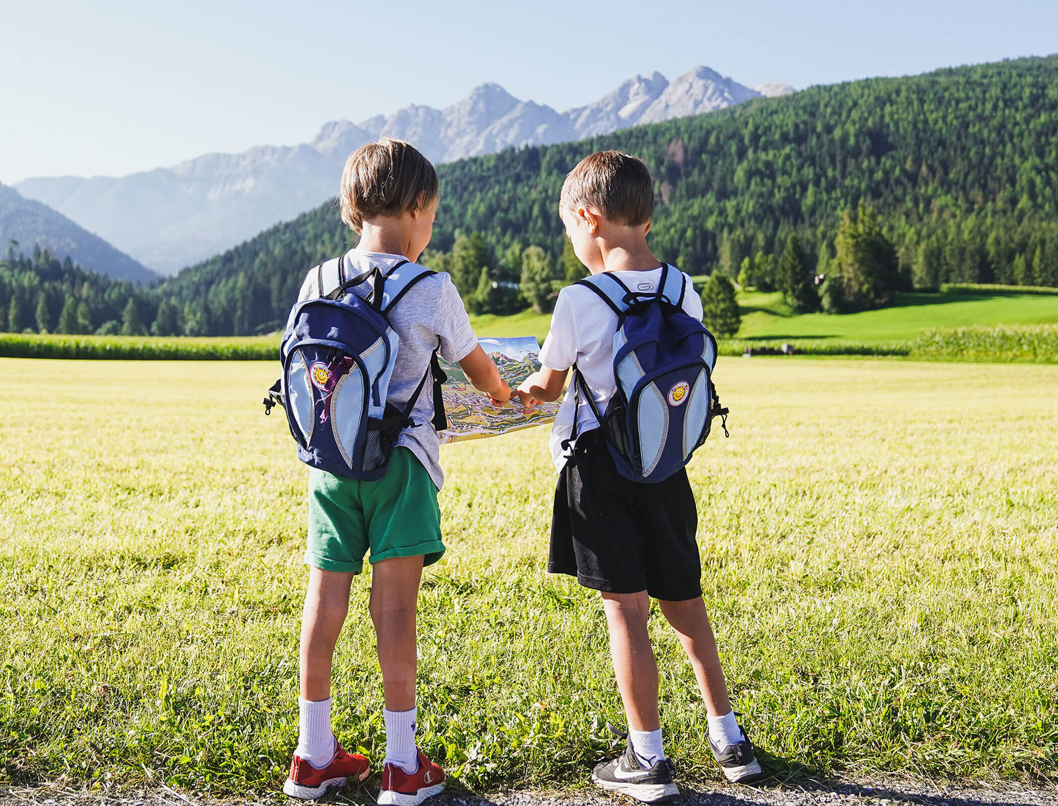 Children look at a hiking map